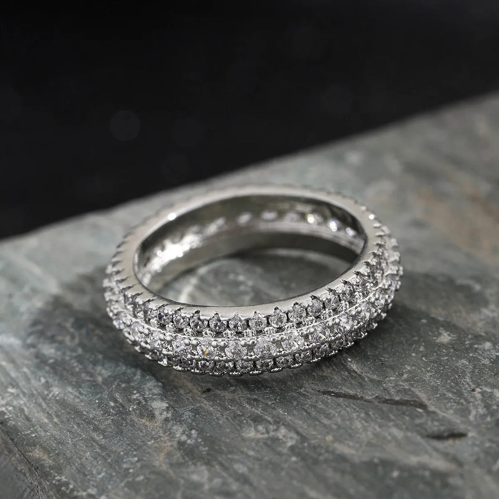 Geometric triangle engagement ring with zircon stone in yellow gold finish on a copper band.