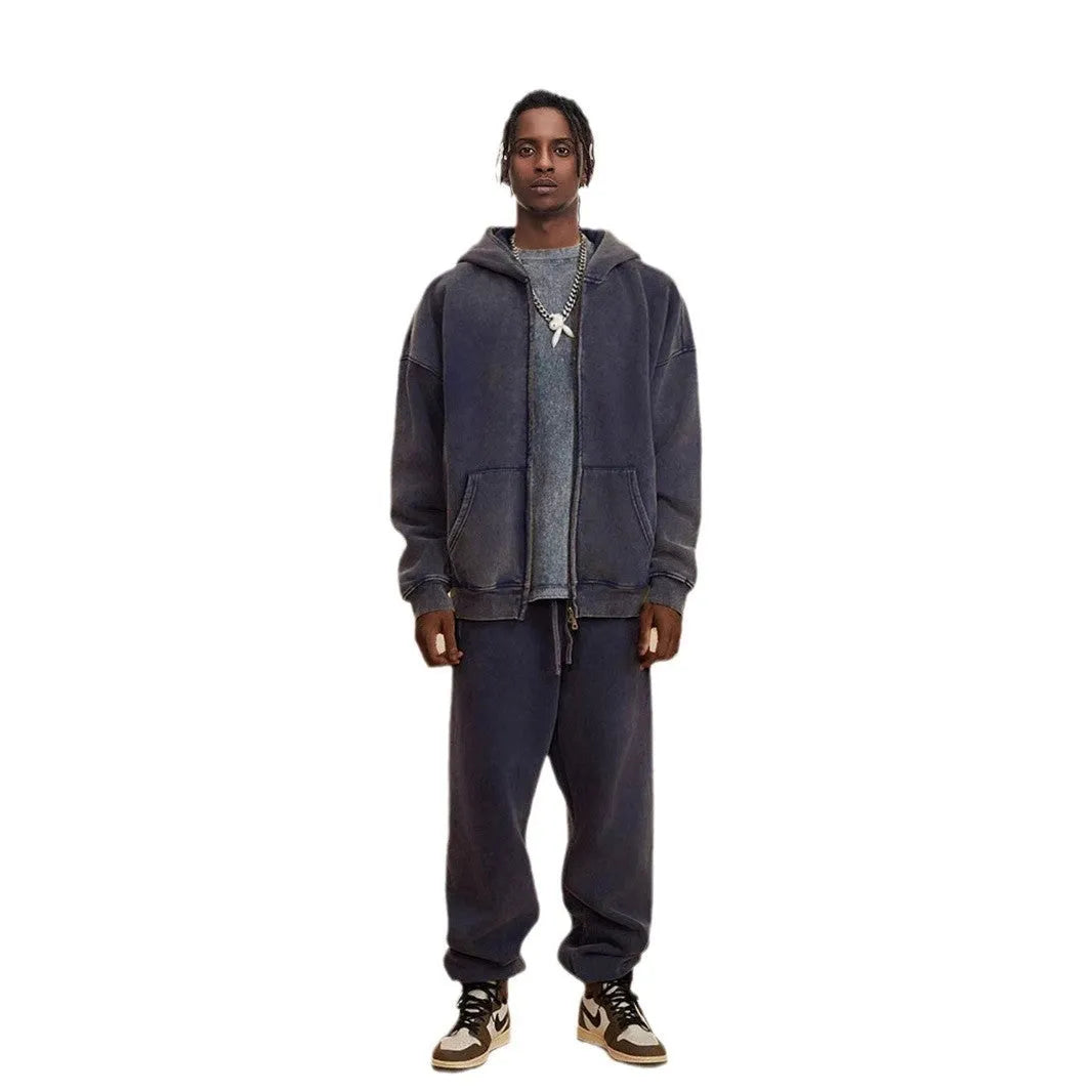 Man wearing a washed black hooded cardigan with a double zipper and fleece lining