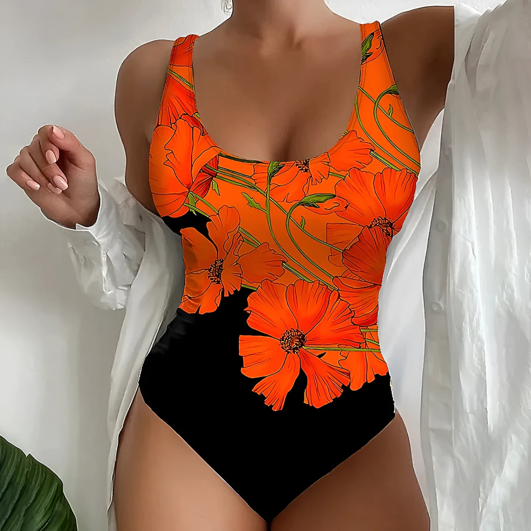 Orange floral print women's backless one-piece swimsuit on a white background.