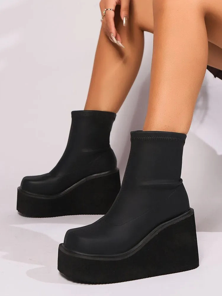 Women's black wedge heel boots with round toe, waterproof platform, and high cylinder design