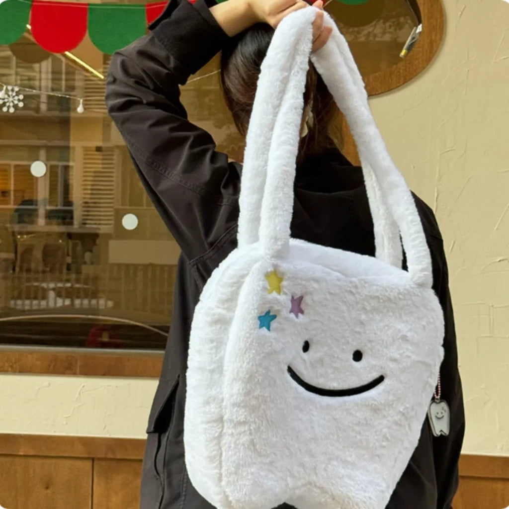 White plush shoulder tote bag with large tooth pattern decoration and zipper closure