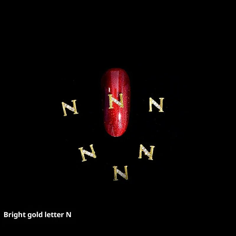Gold alloy letter A nail ornament charm with crystal detail on a square chain base