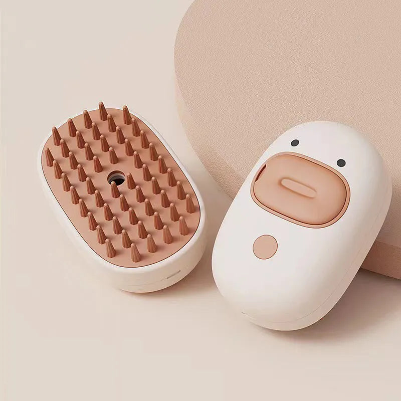White rechargeable pet steam brush with silicone comb teeth for grooming dogs and cats.