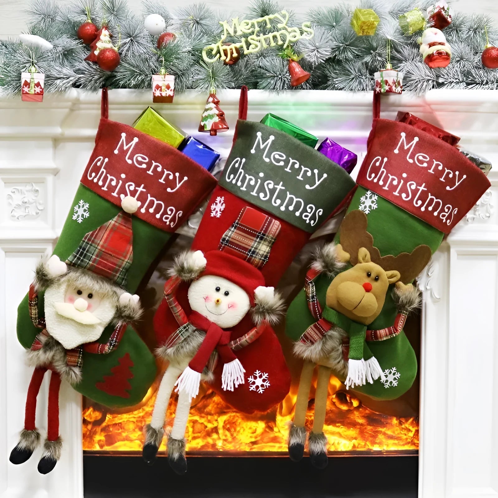Set of three large 18-inch Christmas stockings with Santa, Snowman, and Reindeer 3D applique designs, hanging on a wooden mantel with festive decorations.