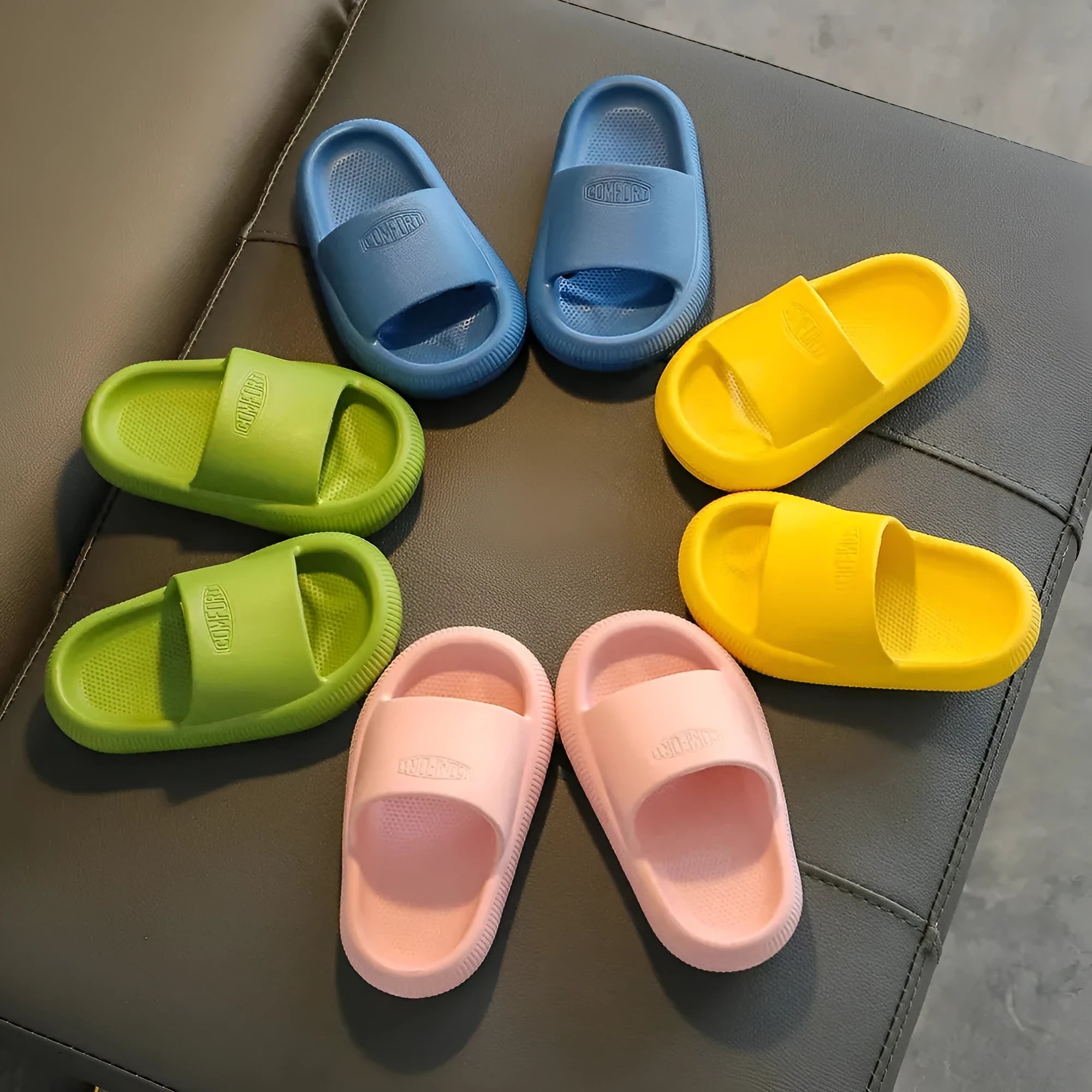 Children's bright coloured EVA slippers with non-slip soles in blue, green, orange, pink, and yellow.