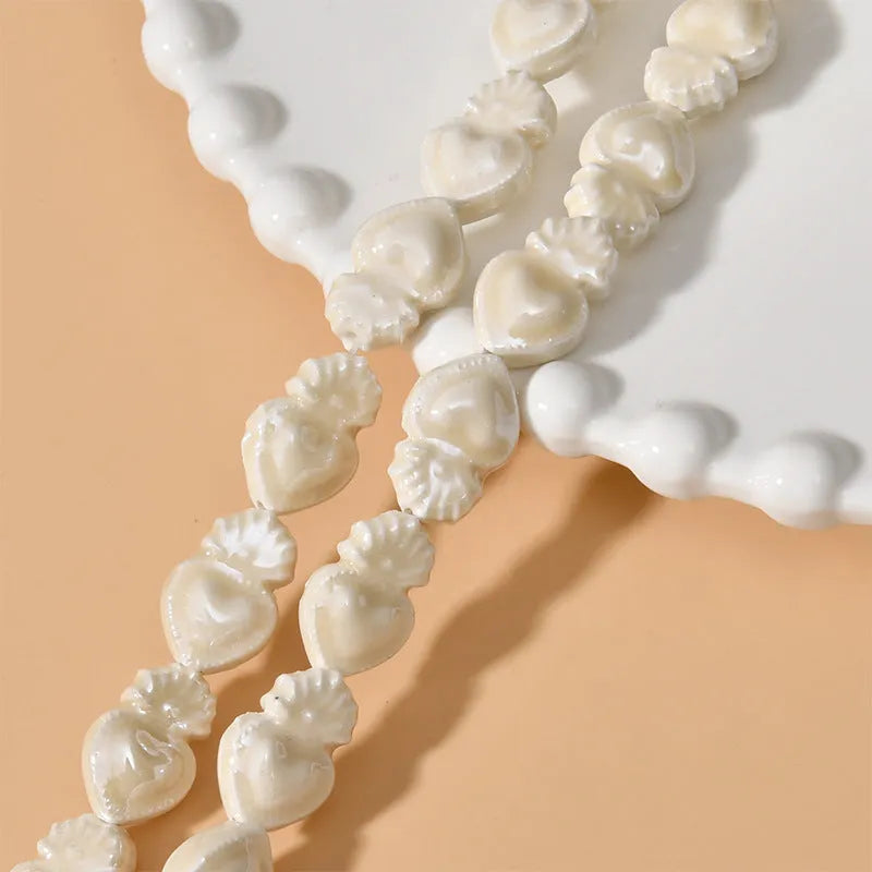 Ceramic heart torch beads in various colours for jewellery making, approximately 10mm by 15mm with straight hole