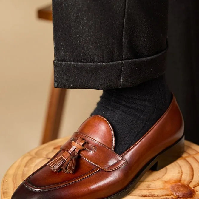 Men's black and brown polished leather tassel loafers with pigskin lining and rubber soles