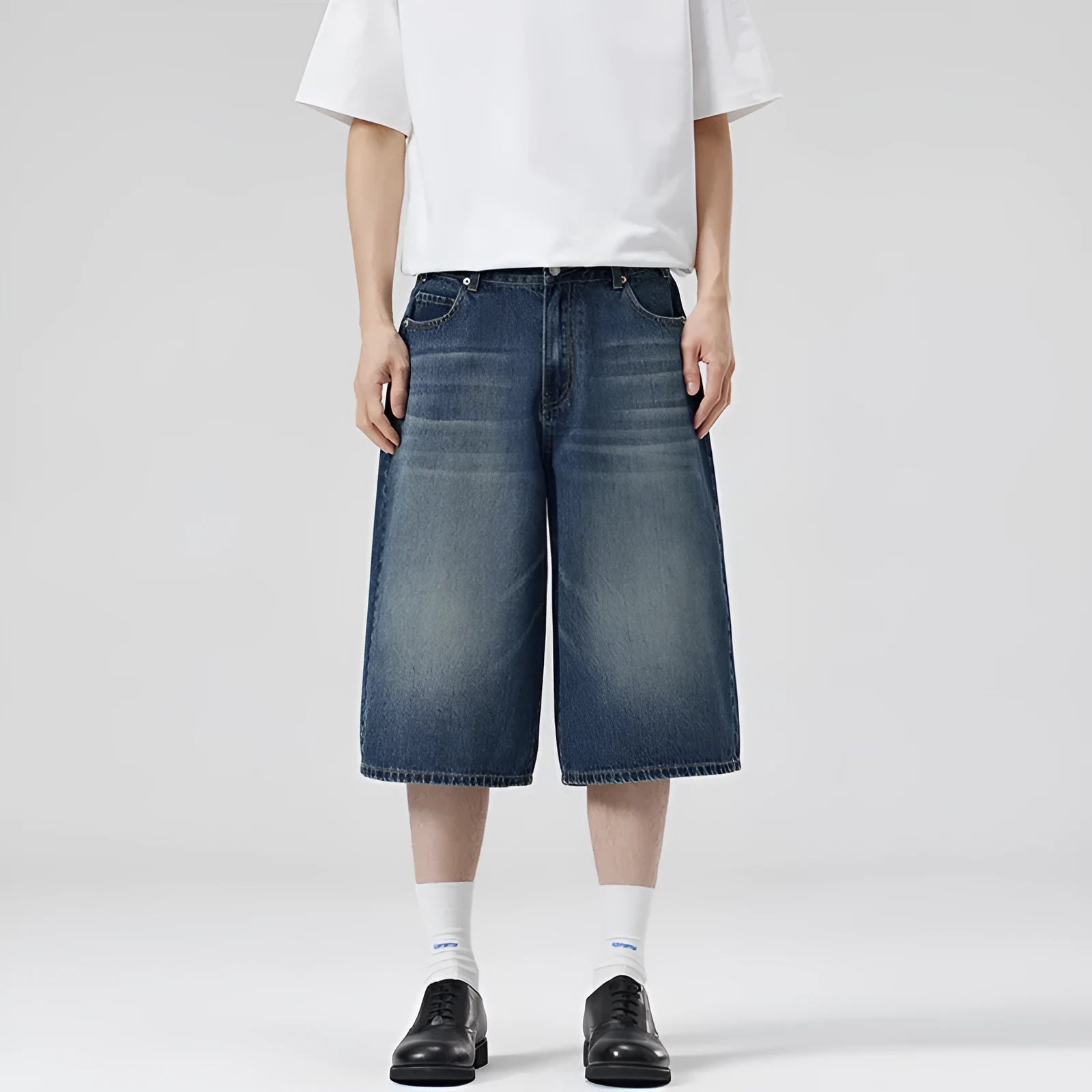 Men's loose fit straight-leg denim shorts in light blue on a plain background