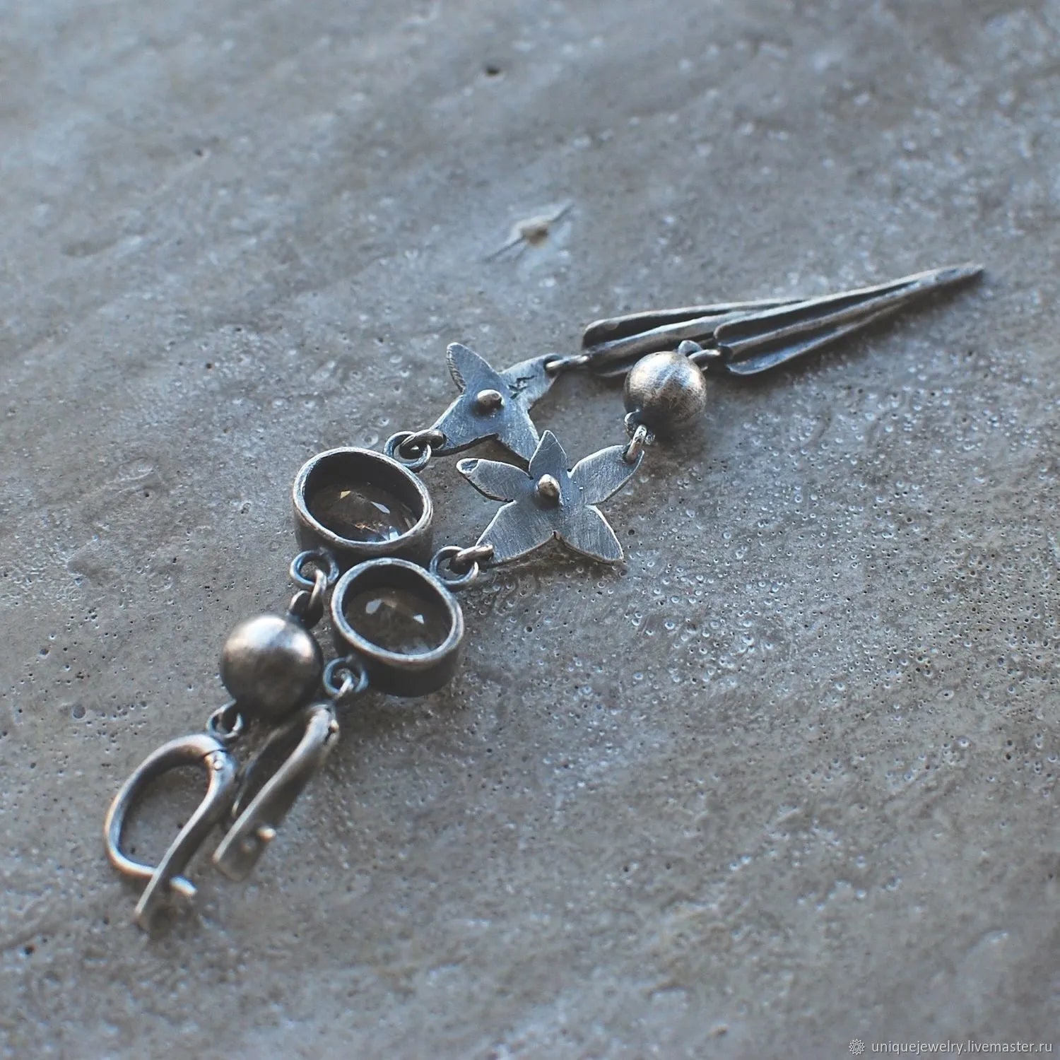 A pair of long geometric XINGX pendant earrings in antique silver with rhinestones.