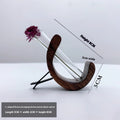 Wooden C-shaped car flower container in Beech finish on a car air vent