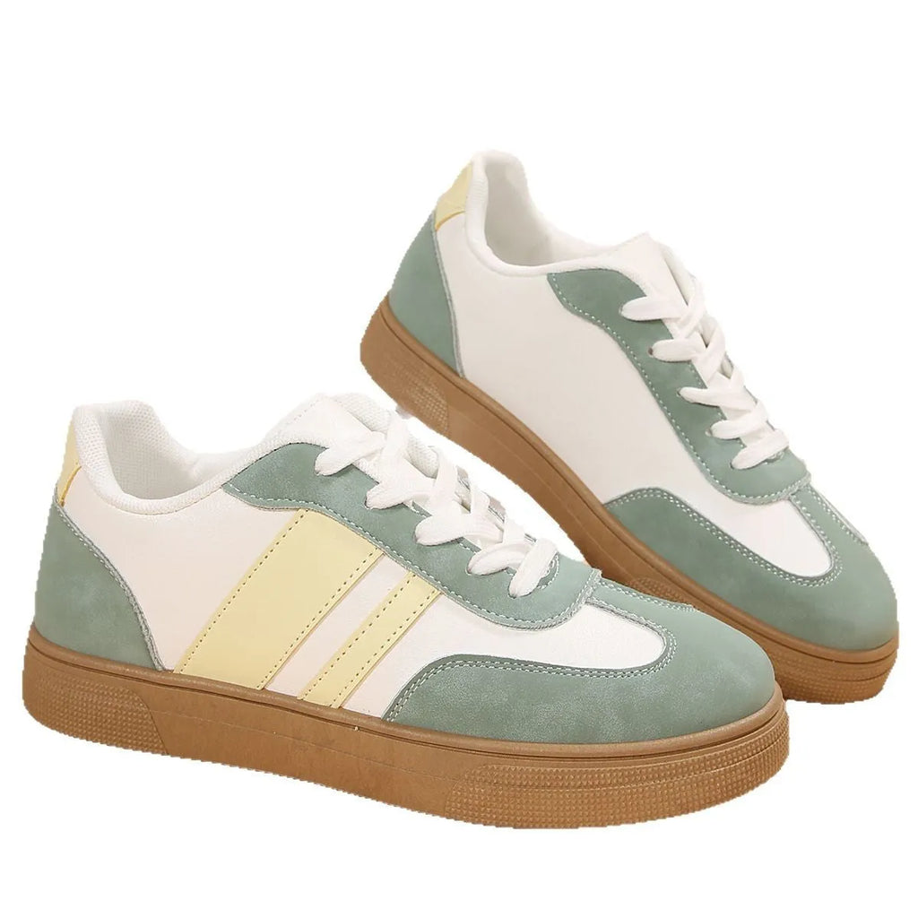 Green women's retro sports low-top shoes with cross straps and round toe on a rubber sole.