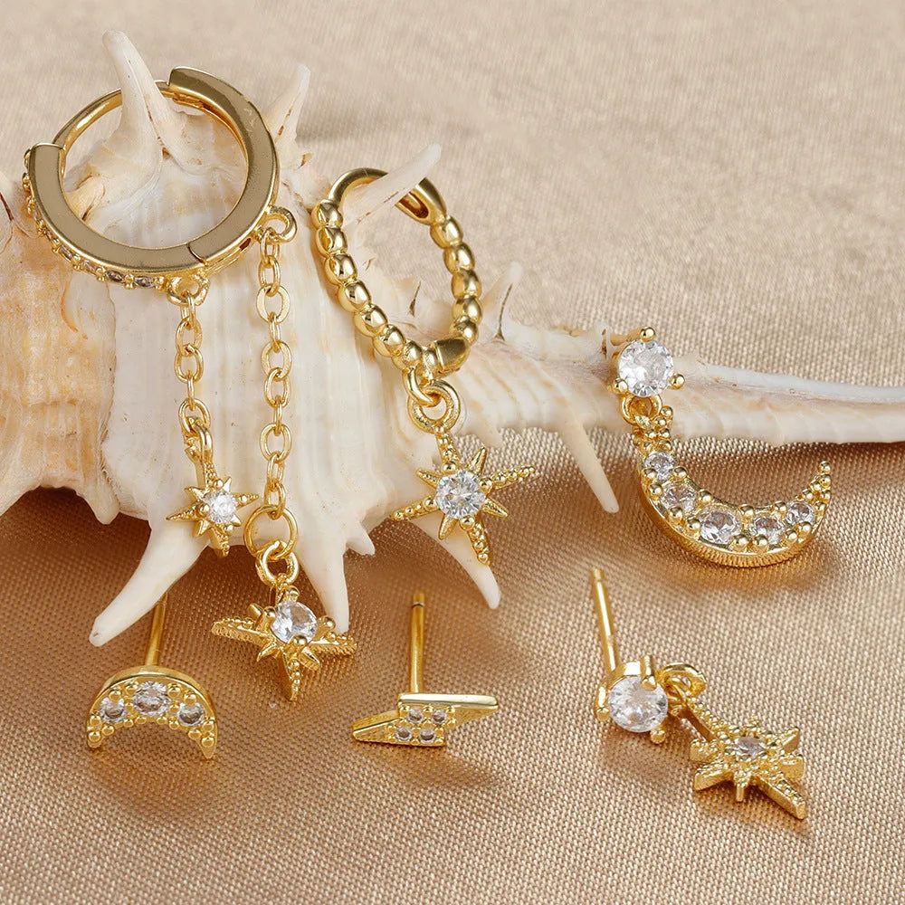 XINGX set of six gold electroplated chain tassel earrings with zircon studs on display