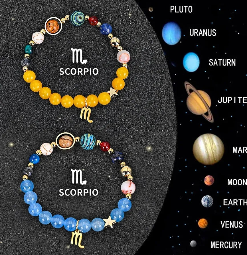 Two natural stone beaded bracelets with zodiac sign charms on a wooden surface