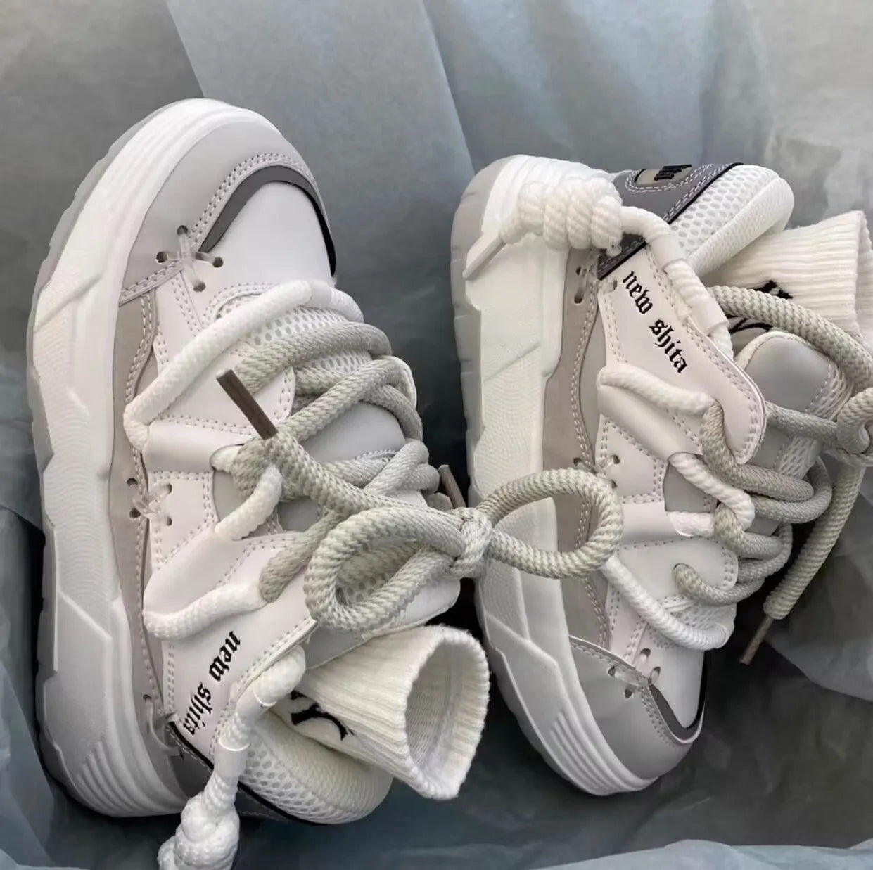 Women's grey retro clunky sneakers with thick rubber sole and lace-up front, showing 6-8cm heel height