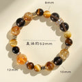 Close-up of a women's bracelet with large 10mm natural yellow artificial crystal beads on a string.