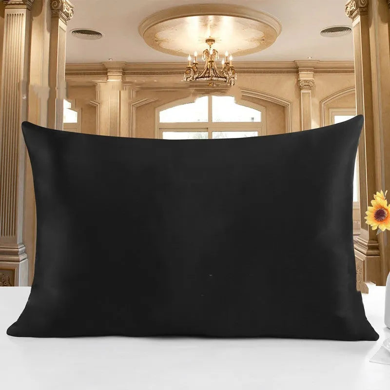 19 M double-sided silk pillowcase in apricot colour on a bed.