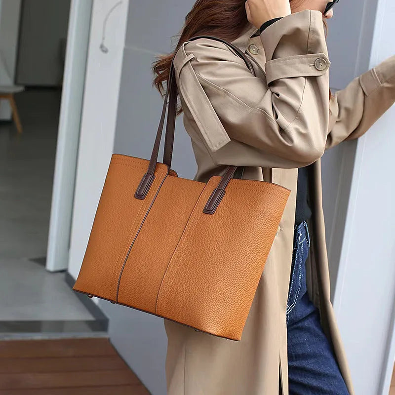 Women's black genuine leather crossbody bag with internal organiser compartments showing document and phone sections