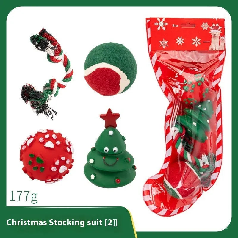 Christmas-themed vinyl dog toys including barbell, ball, rope, and Santa designs in gift packaging