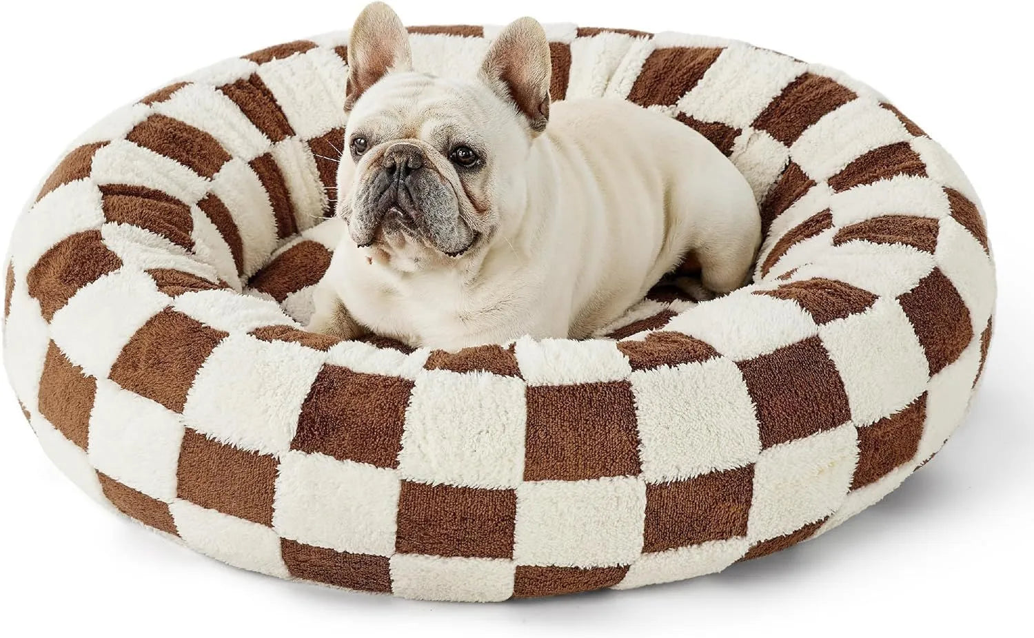 Round plastic dog bed with a blue and white plaid fabric cover, shown on a wooden floor.