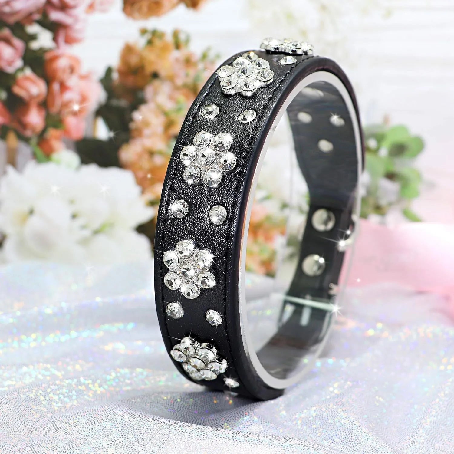 Decorative black PU leather dog collar with studded rhinestone flower pattern and silver metal D-ring.