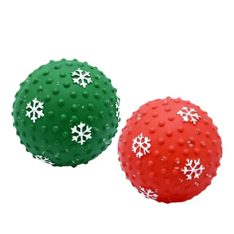 Red dog toy ball with squeaker and air vents, 7 cm diameter, floating on water