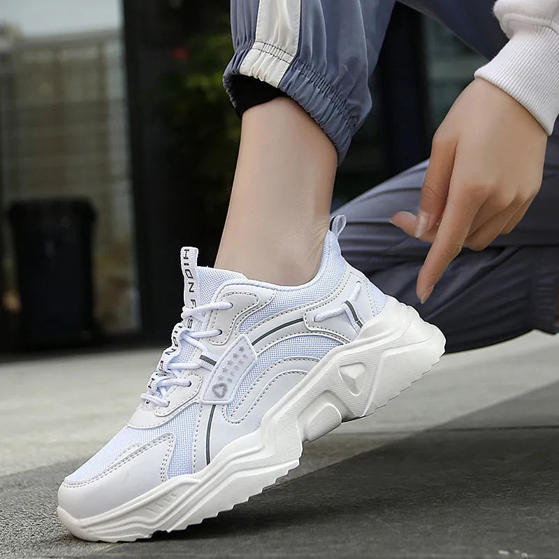 Women's white thick-soled casual sports shoes with mesh upper, round toe, and buckle closure.