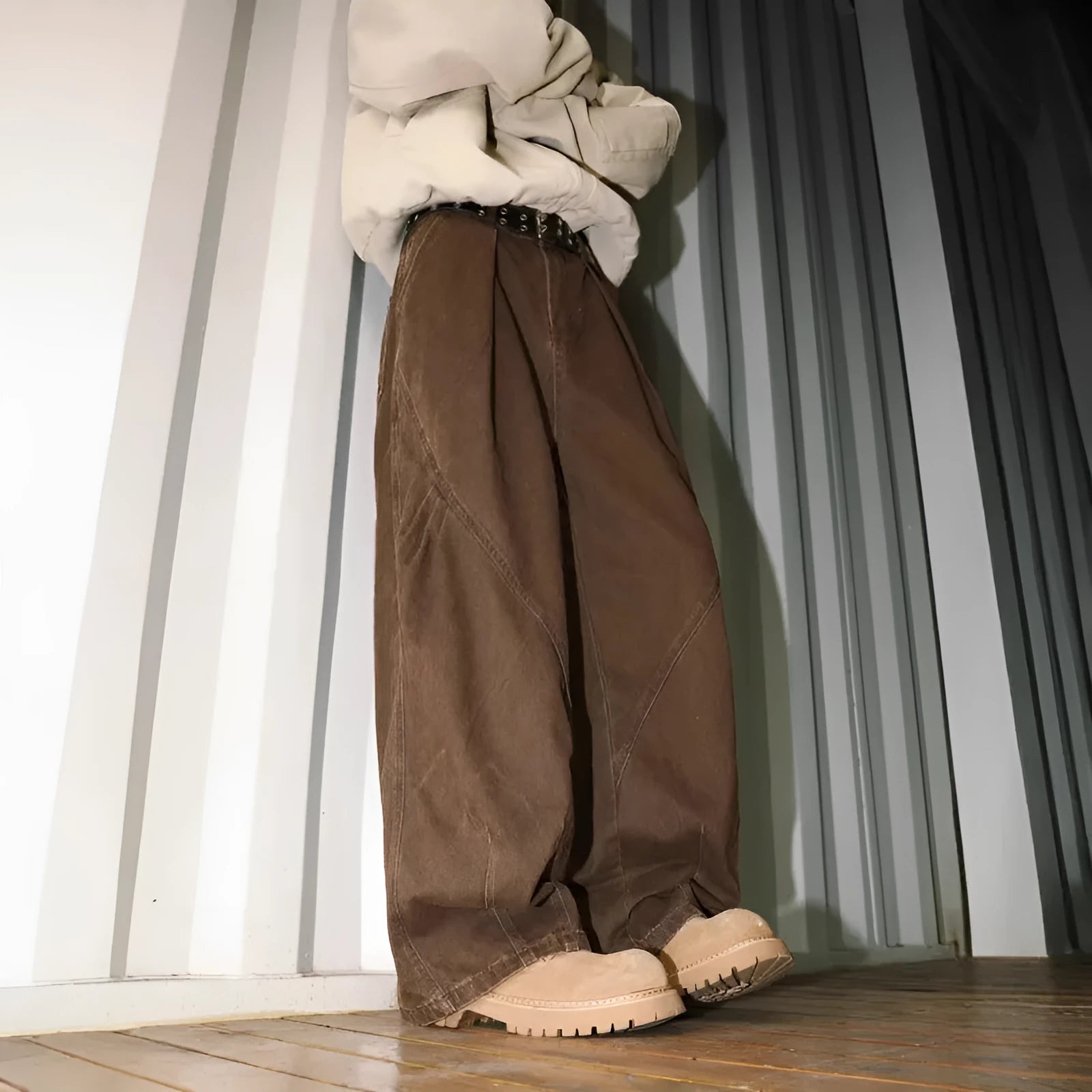 Men's pleated straight loose trousers in black striped pattern showing straight leg design
