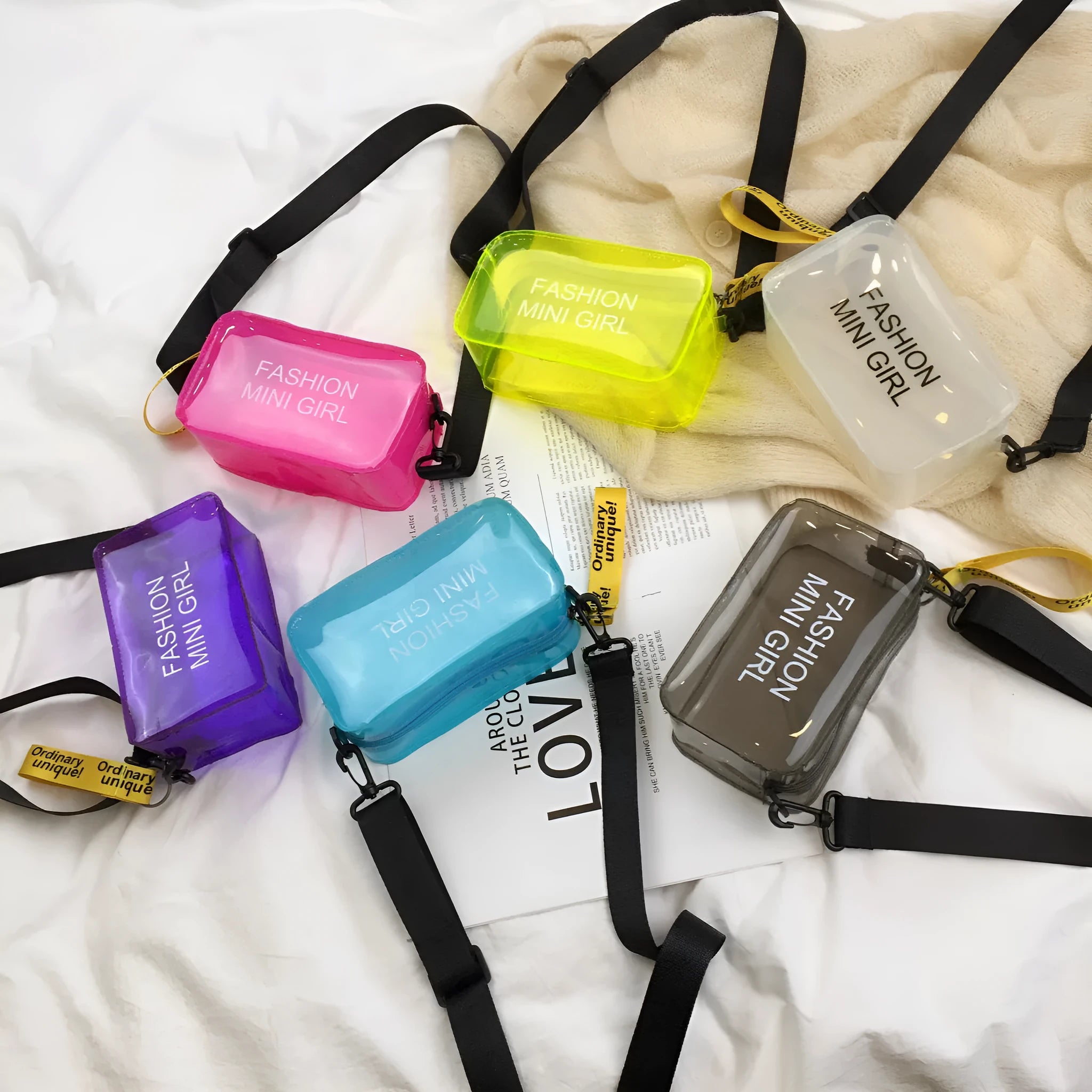 Clear square jelly shoulder bag with adjustable strap in various colours on a white background.