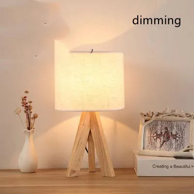 Japanese style solid wood table lamp with fabric lampshade in linen trumpet colour on bedside table