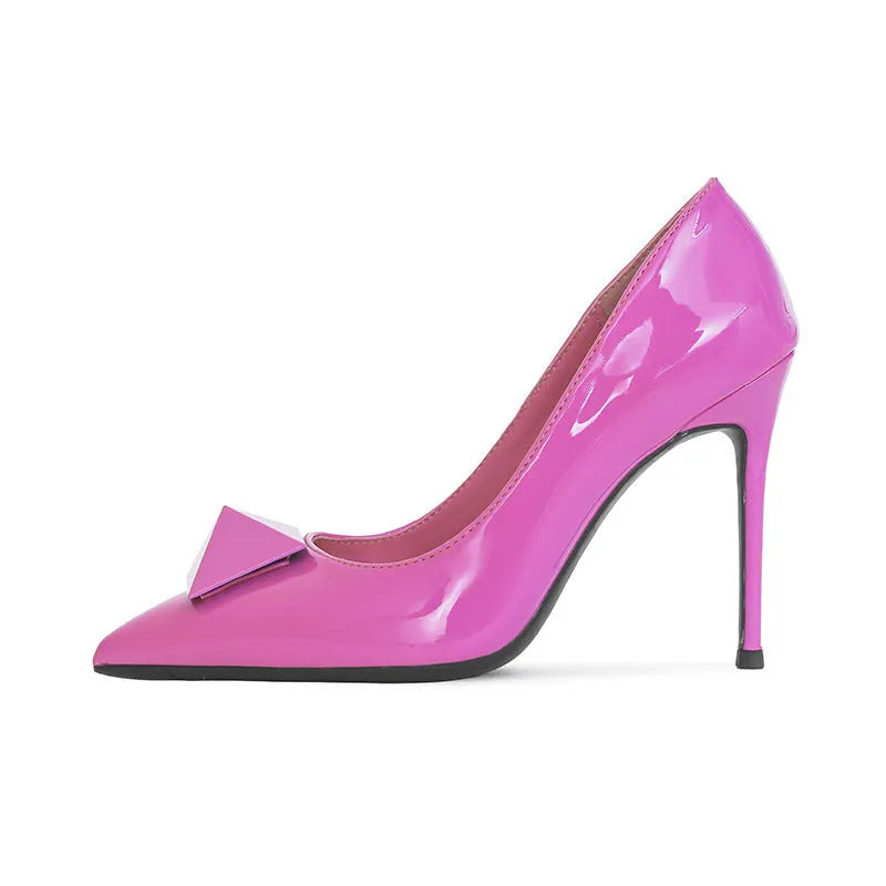 Pink patent leather women's pointed toe stiletto high heels with a buckle detail on the upper.
