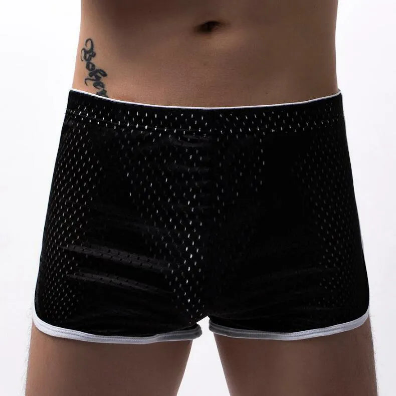 Men's solid colour boxer shorts in a cotton and nylon fabric blend, shown in black, on a mid-waist fit model.