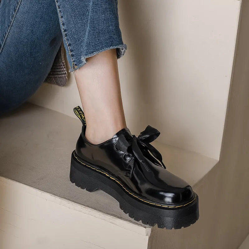 Women's black thick-soled leather shoes with cross straps and ribbon decoration