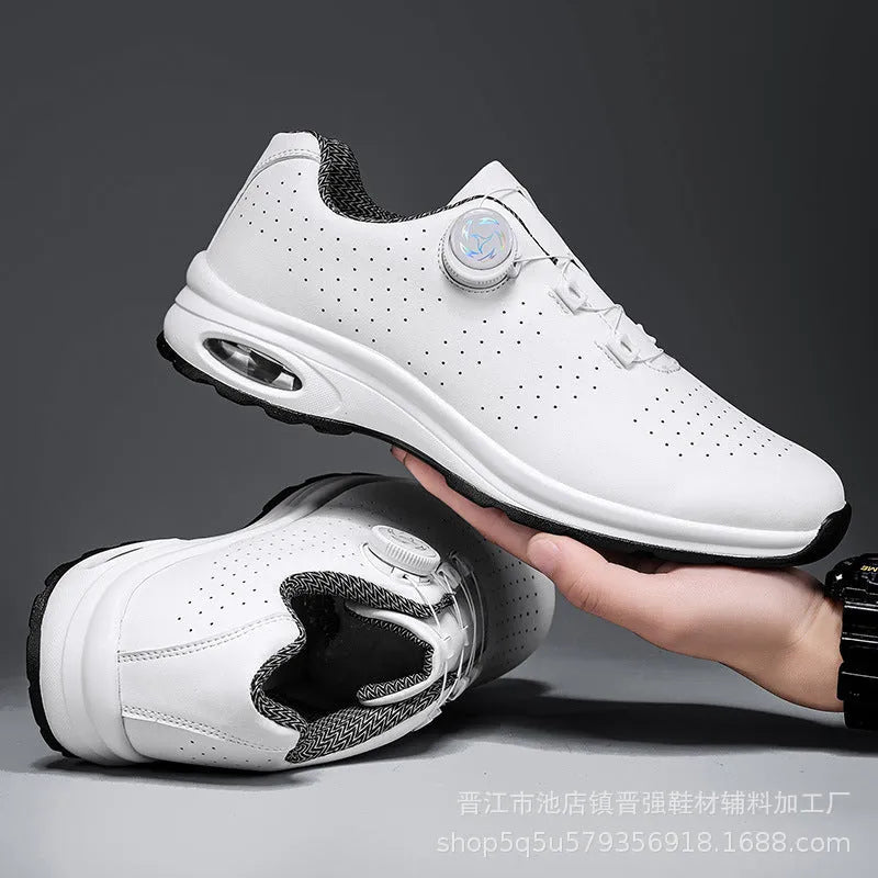 Low-top black and white tennis shoes with mesh uppers, cross shoulder straps, and a flat composite sole.