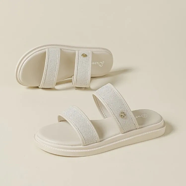 Women's vintage brown and black soft-bottom flip-flops made from artificial PU leather, showing retro strap design.