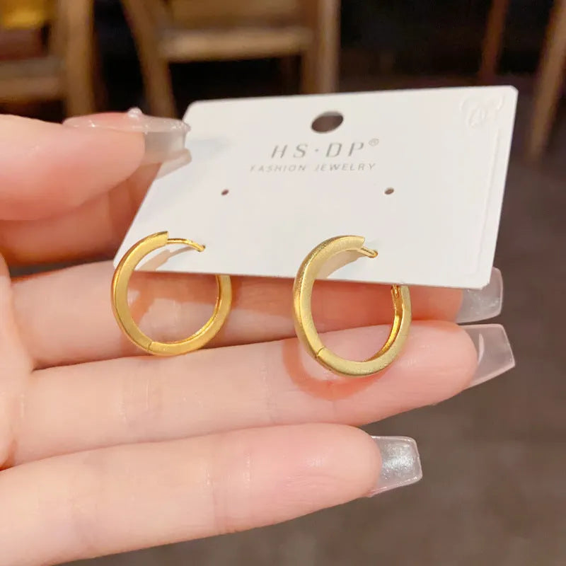 Geometric women's ear clip jewellery with simple eyelet design in gold or silver colour