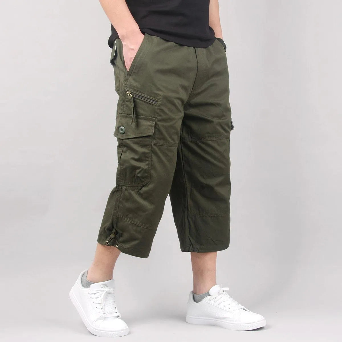 Men's loose fit cotton cropped pants in army green colour, shown on a hanger.