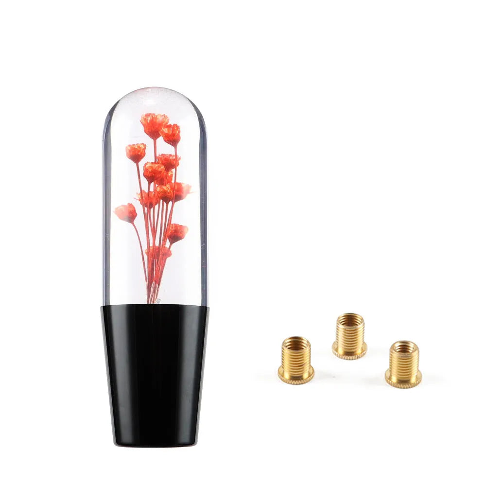 Transparent crystal car gear shift knob in assorted colours with three metal adapters.