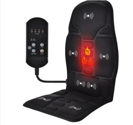 Black electric cervical massager with wireless remote on a table next to international power plugs.
