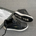 Men's black PU leather round toe board shoes with thick rubber sole on plain background