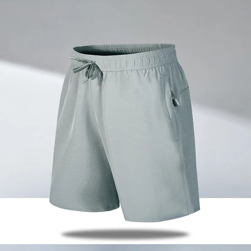 Man wearing loose-fit black quick-drying polyester beach shorts with a micro-elastic waistband.