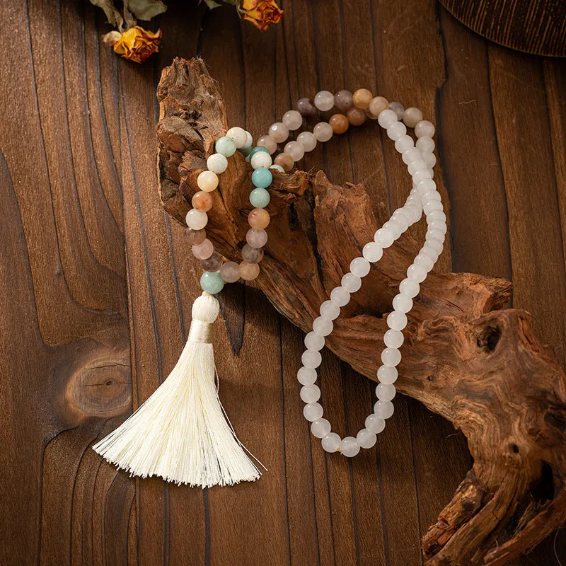 Vintage bohemian long necklace with geometric stone beads and tassel, shown with a matching shorter bracelet.