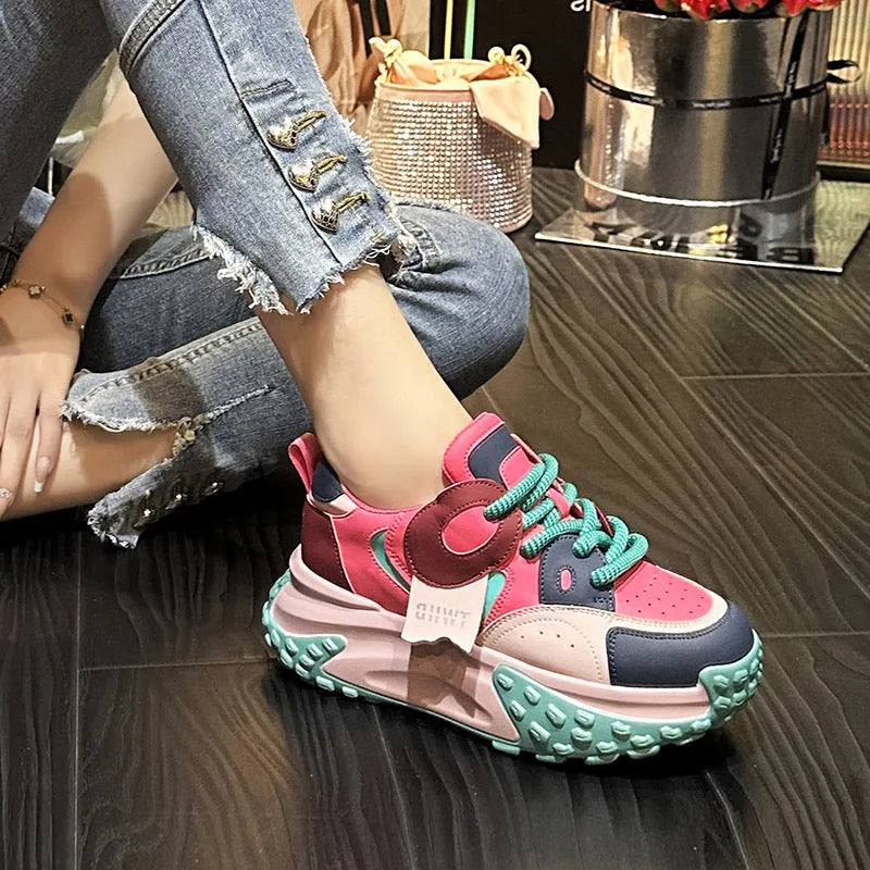 A pair of thick-soled leather casual shoes with a wedge heel and front lace-up design.