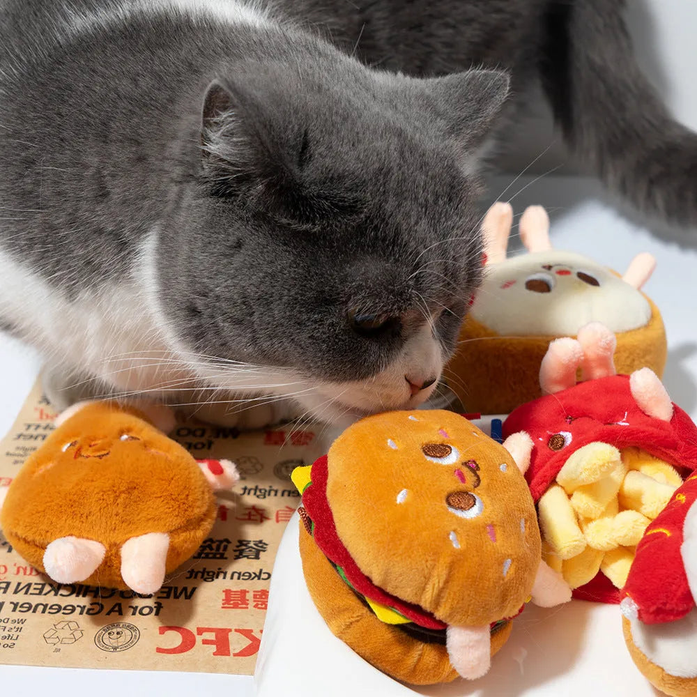 Assorted soft kitten teething toys shaped like a hamburger, chicken leg, fries, bread, and hot dog.