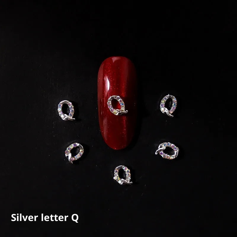 Gold alloy letter A nail ornament charm with crystal detail on a square chain base