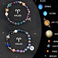 Pair of natural stone beaded bracelets with zodiac charms on an adjustable cord.