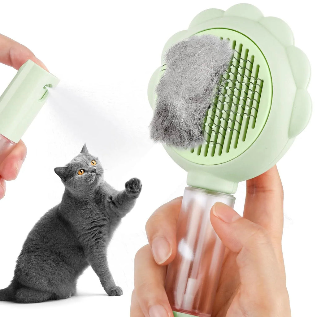 Grey self-cleaning cat brush with spray function and stainless steel bristles on a white background.