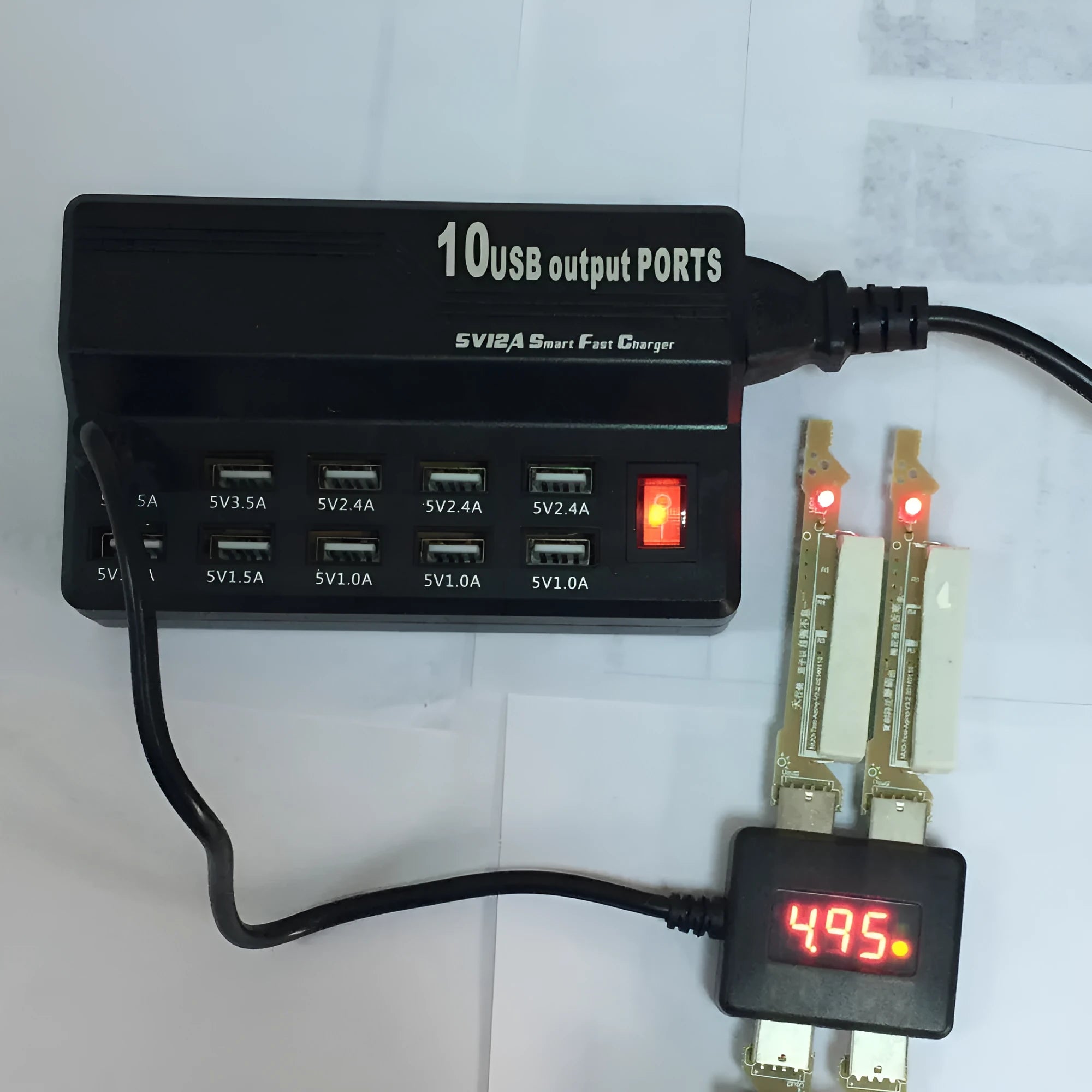 Black 10-port USB charging power strip with smart charging and aluminium heat dissipation, shown with multiple cables connected