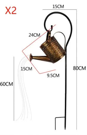 Enchanted watering can solar lamp with warm white star-shaped LED lights in a garden setting