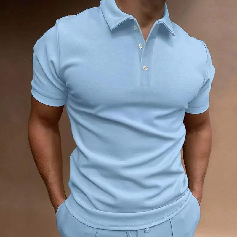 Man wearing a loose fit grey cotton blend T-shirt with a button-down front and short sleeves.