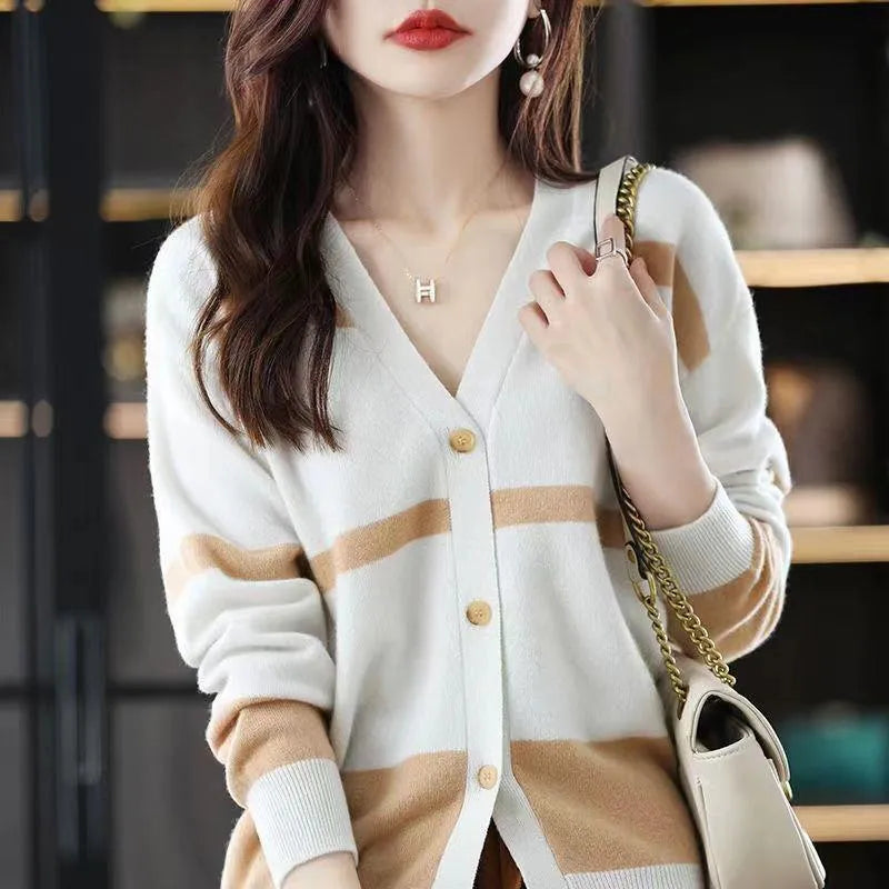 Women's black and white striped V-neck knitted cardigan with 3D pattern on a hanger.